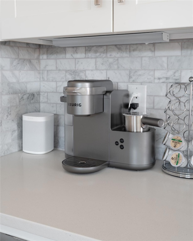 Kitchen view of white cabinets, light countertops