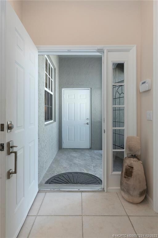 View from foyer to the front entry porch & garage door access