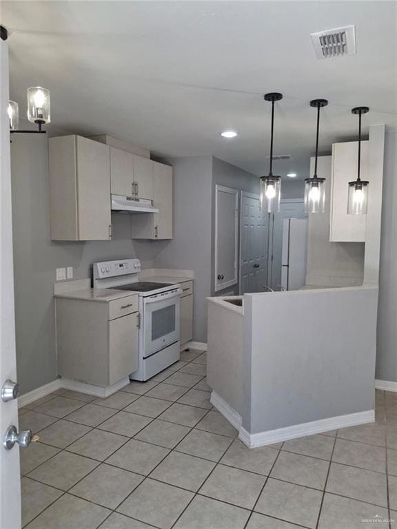 Kitchen with hanging light fixtures, white appliances, light tile patterned flooring, light countertops, and recessed lighting