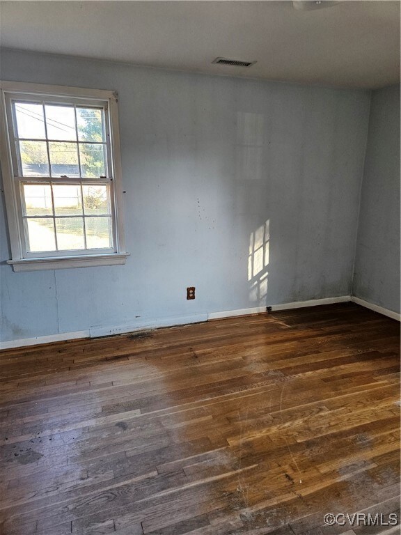 Spare room featuring dark hardwood / wood-style fl