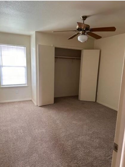 Unfurnished bedroom featuring a closet, light colo