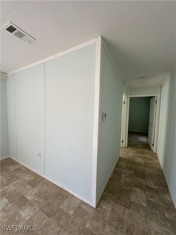 Corridor with tile patterned flooring