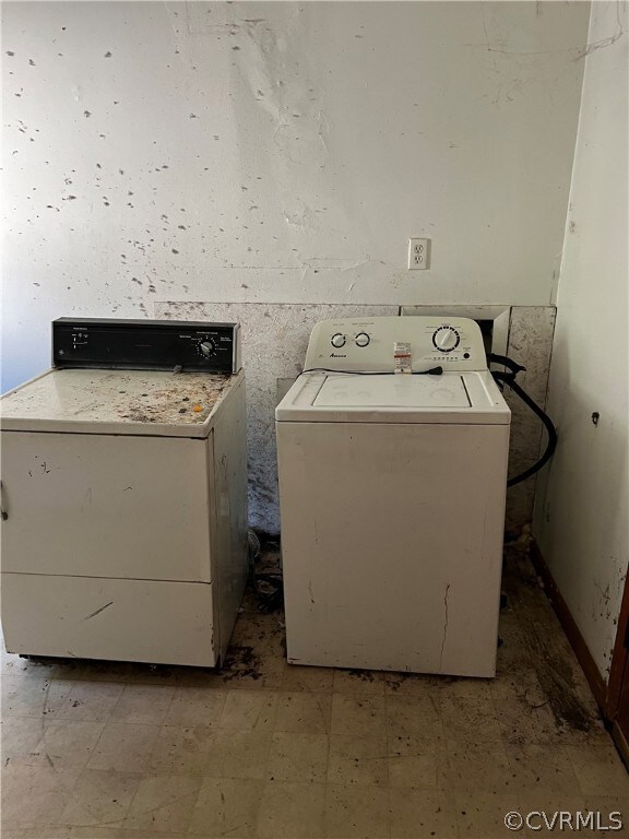 Washroom with washing machine and clothes dryer an