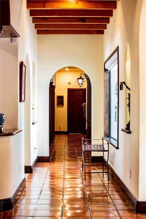 Hallway featuring beam ceiling and hardwood / wood-style floors