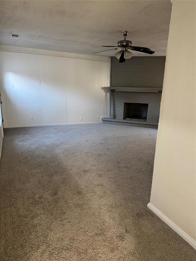 Unfurnished living room with a fireplace, carpet, 