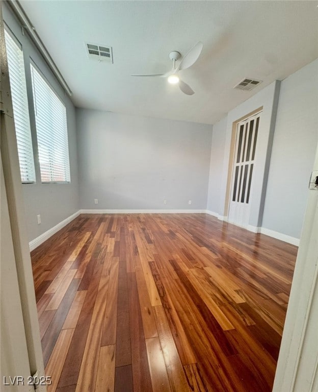 Unfurnished room featuring ceiling fan and hardwoo