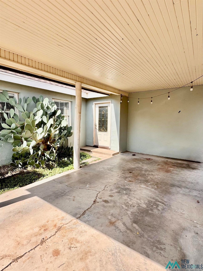 Garage featuring an attached carport