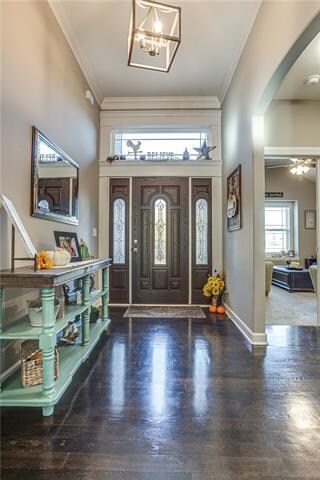 Welcome home to 11' ceilings & wide plank hardwood