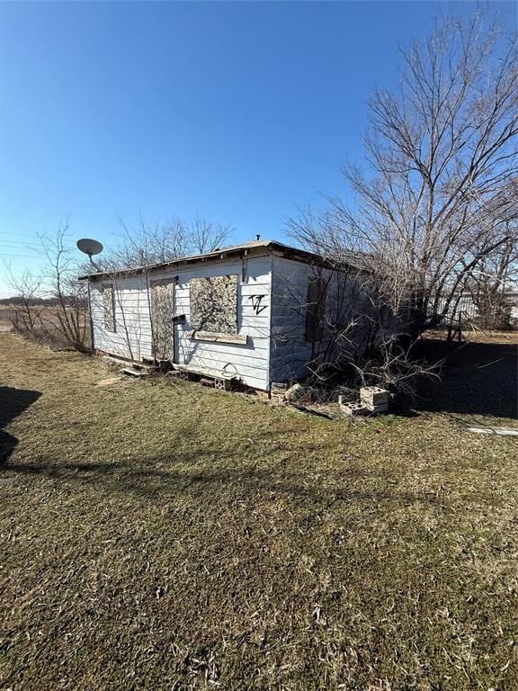 View of property exterior with a yard