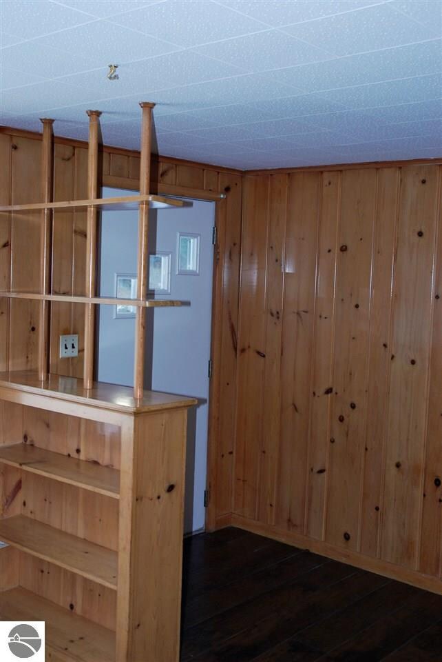 View of front entry with small built-in book case.
