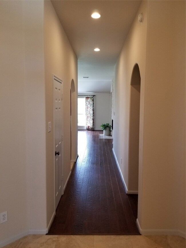 As you walk in the front door, you pass the Formal Dining on the Left and the Study on your right, and walk down the hallway into the Family Room.
