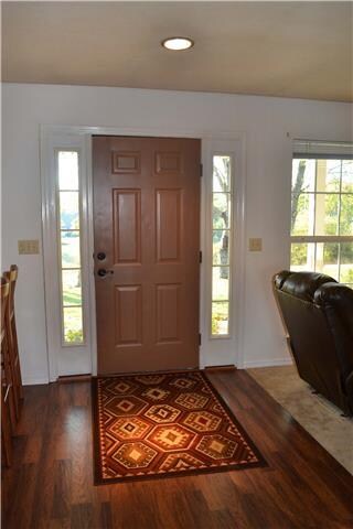 Full view glass sidelights frame the Front Door for a welcoming Entry as well as allow an abundance of natural lighting into the home. The open floor plan allows for the Entry to be open to the Kitchen, Dining Area, and Living Room.