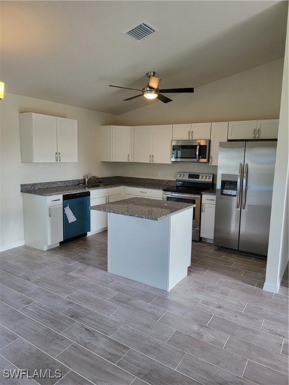 Kitchen with range, wood finish floors, refrigerat