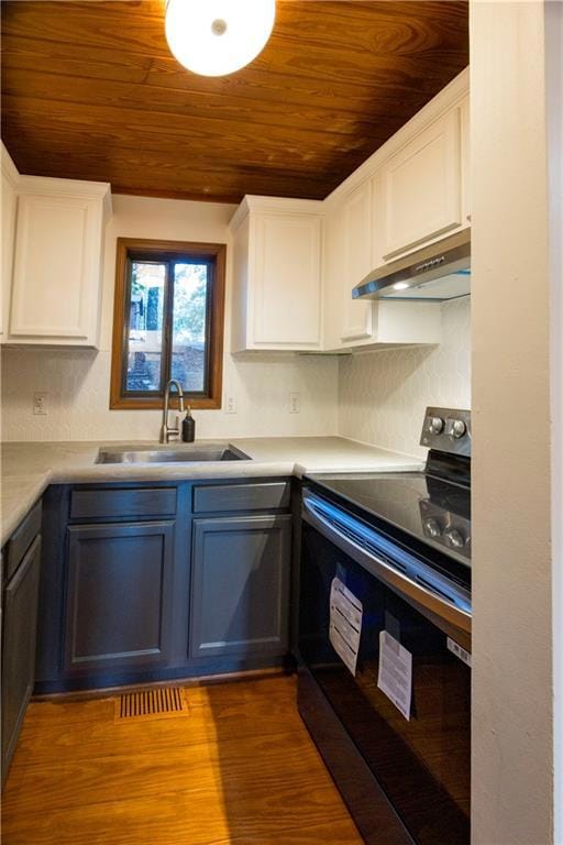 Kitchen featuring hardwood floors, extractor fan, 