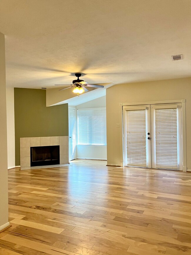 A beautiful living room with wood floors, a fire p
