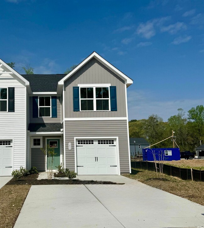 View of front facade with driveway, an attached ga