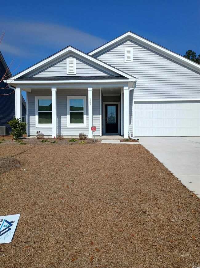 View of front of house featuring a garage, covered