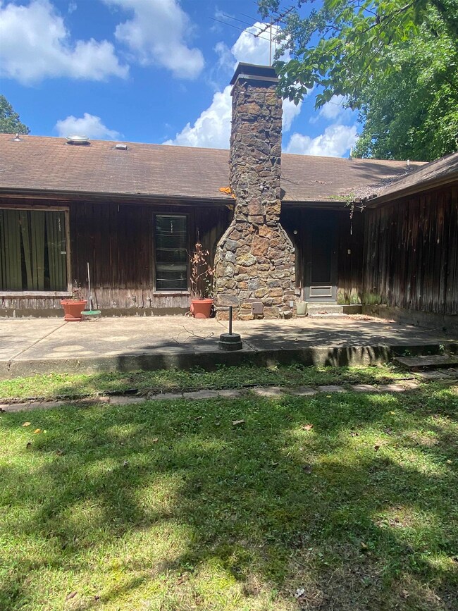 Back of property featuring a patio and a lawn