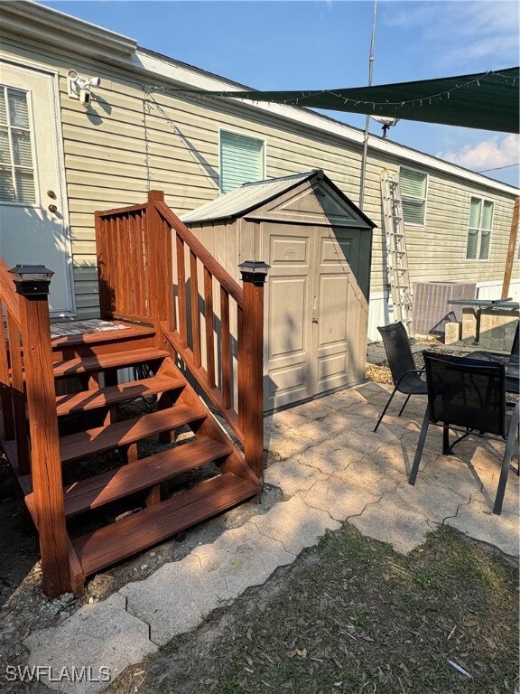 View of rear patio with a storage shed