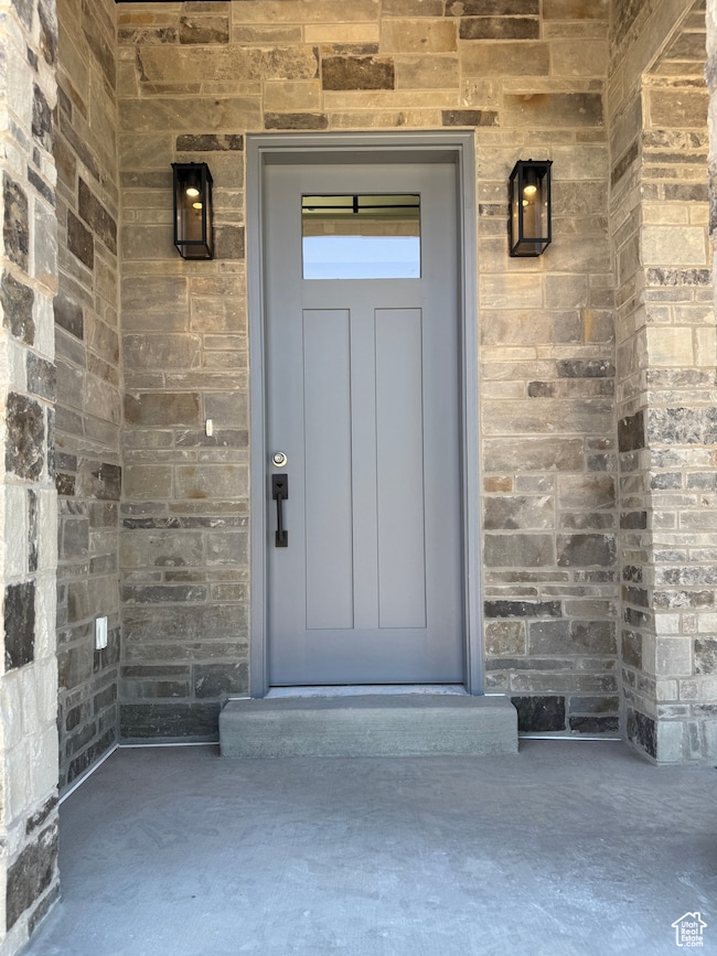Entrance to property with stone siding