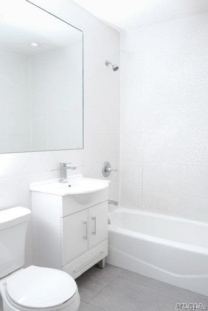 Bathroom with tub / shower combination, light tile patterned floors, and vanity
