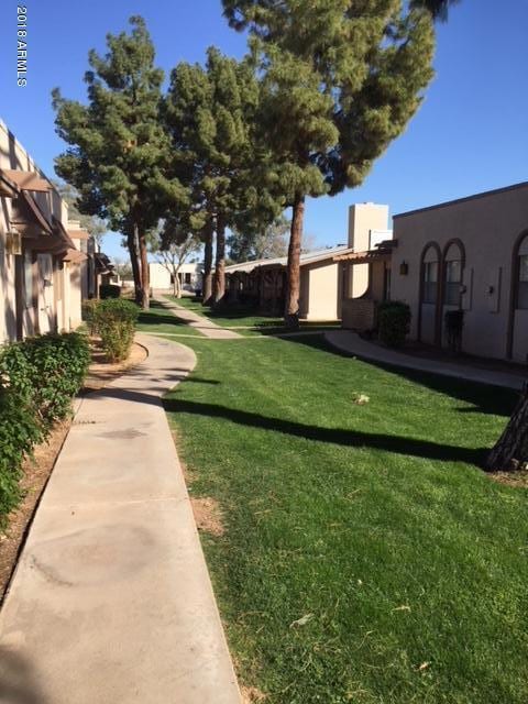 Grassy walkway in front of home