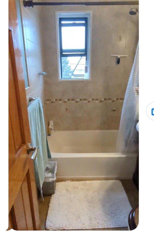 Bathroom with shower / tub combo with curtain