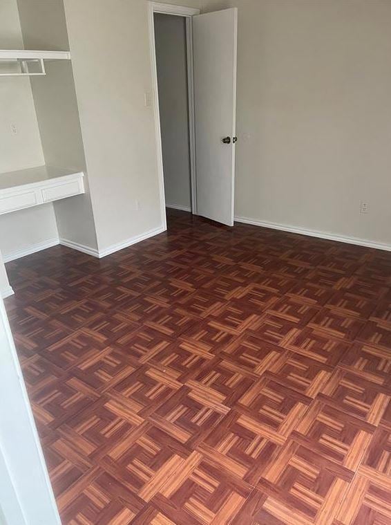 Unfurnished bedroom with baseboards