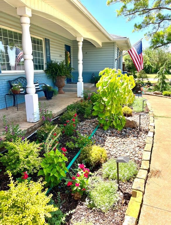 View of home's exterior with covered porch and brick siding