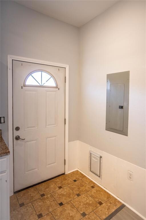 Tiled entrance foyer with electric panel