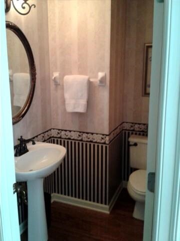 Powder room for guests off entry.