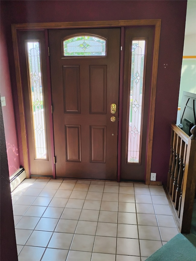 Foyer with a baseboard radiator and plenty of natural light