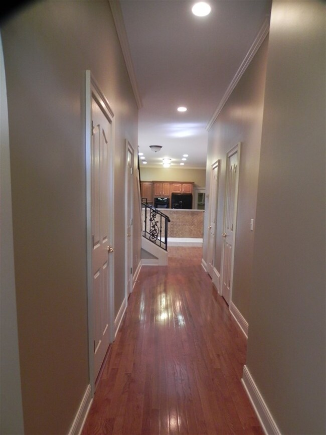 This long hallway with recessed lighting leads you