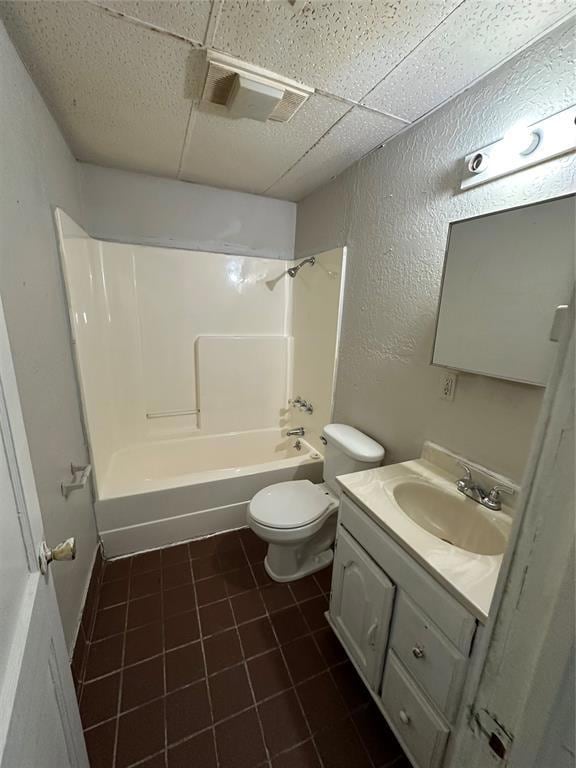 Full bath with a textured wall, toilet, vanity,  s