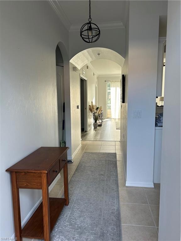 Hall featuring tile floors and crown molding