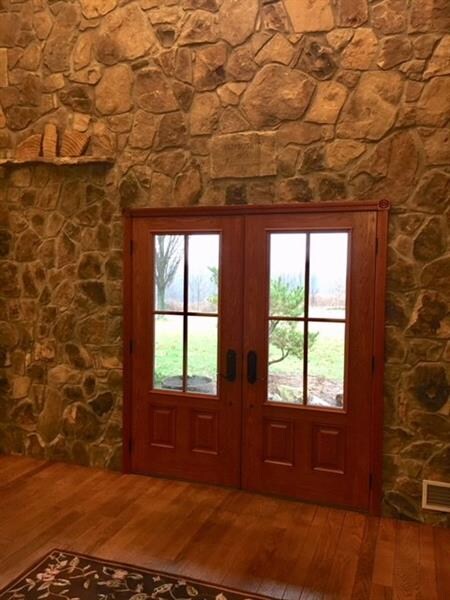 Stonework and Hardwood Floors compliment this Foye