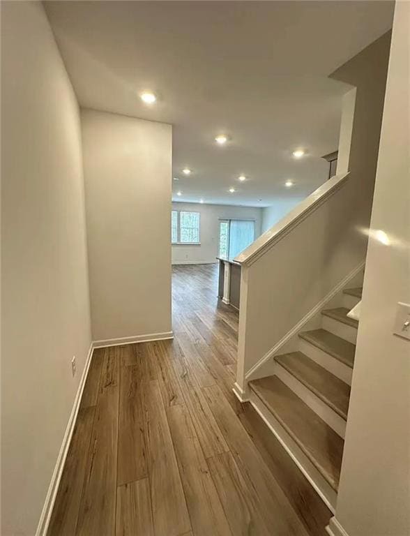 Staircase with baseboards, recessed lighting, and 