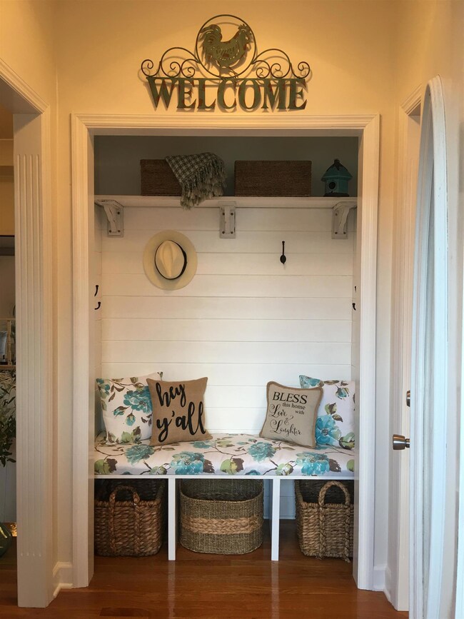 Foyer closet, Chip and Joanna style, complete with shiplap design, bench, hooks, and shelving