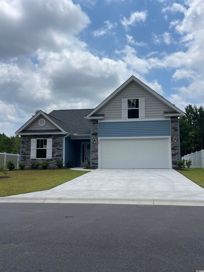 Ranch-style house featuring a garage and a front l