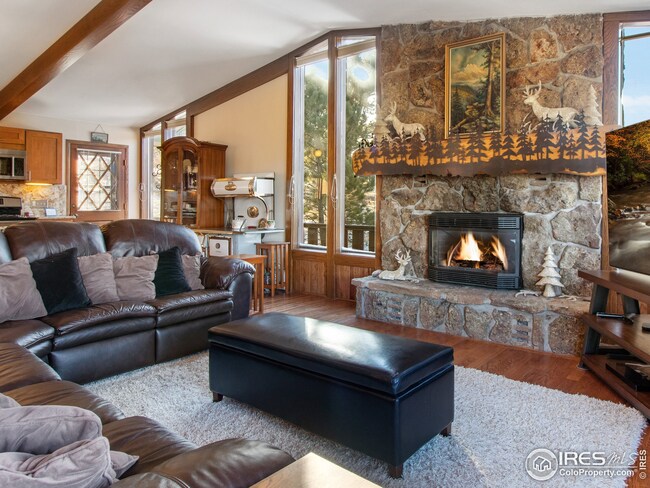 Floor to ceiling moss rock gas fireplace