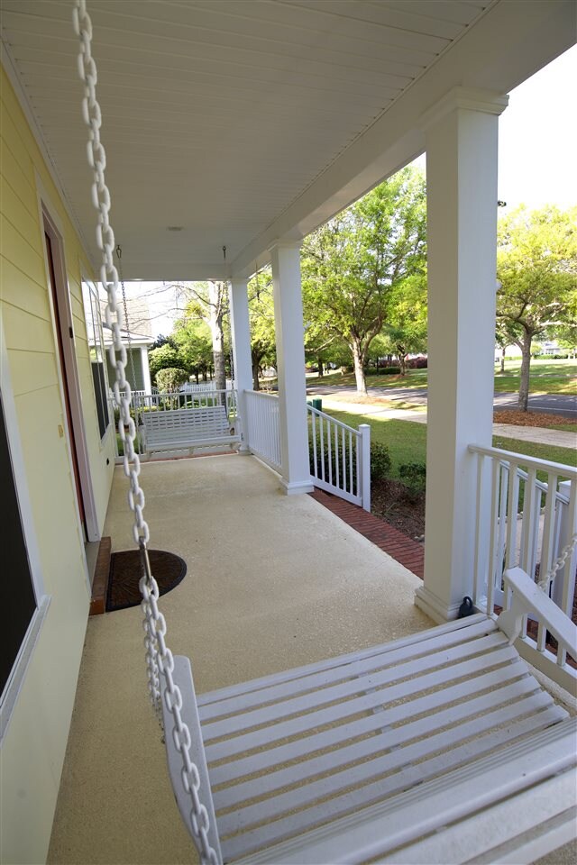 Front porch swings overlook open meadow and nature