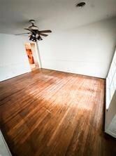 Empty room featuring dark hardwood / wood-style flooring