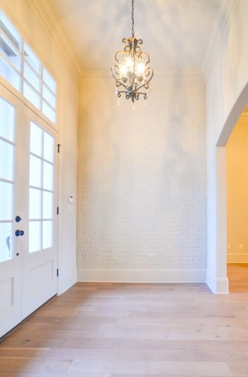 Painted brick accent wall in foyer...elegant light
