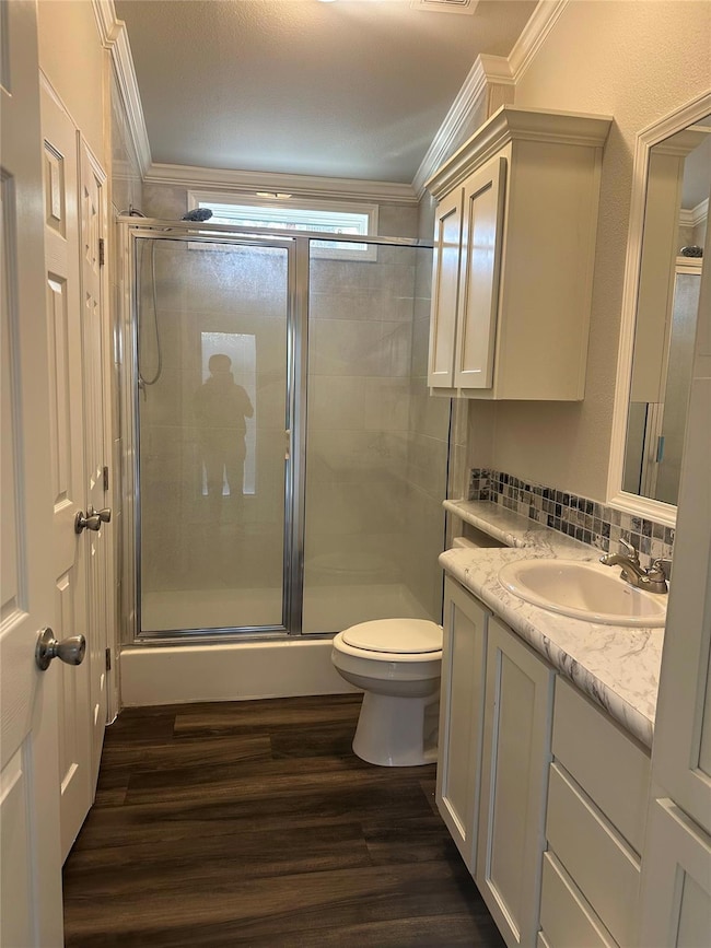 Bathroom with ornamental molding, vanity, wood fi