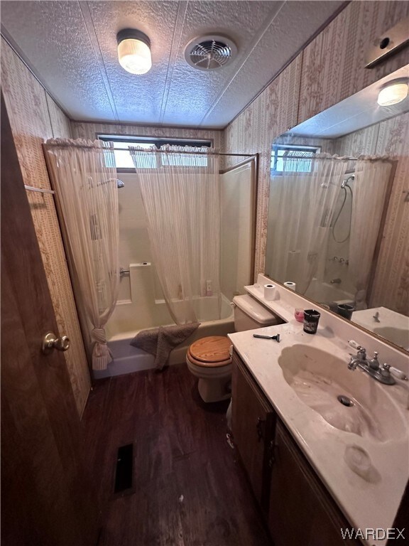 Full bathroom featuring hardwood flooring, bathing