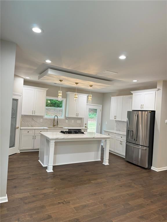 Kitchen with white cabinets, stainless steel fridg
