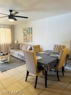 Dining area with a ceiling fan and light tile patt
