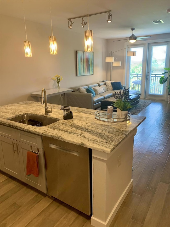 Kitchen featuring open floor plan, rail lighting,