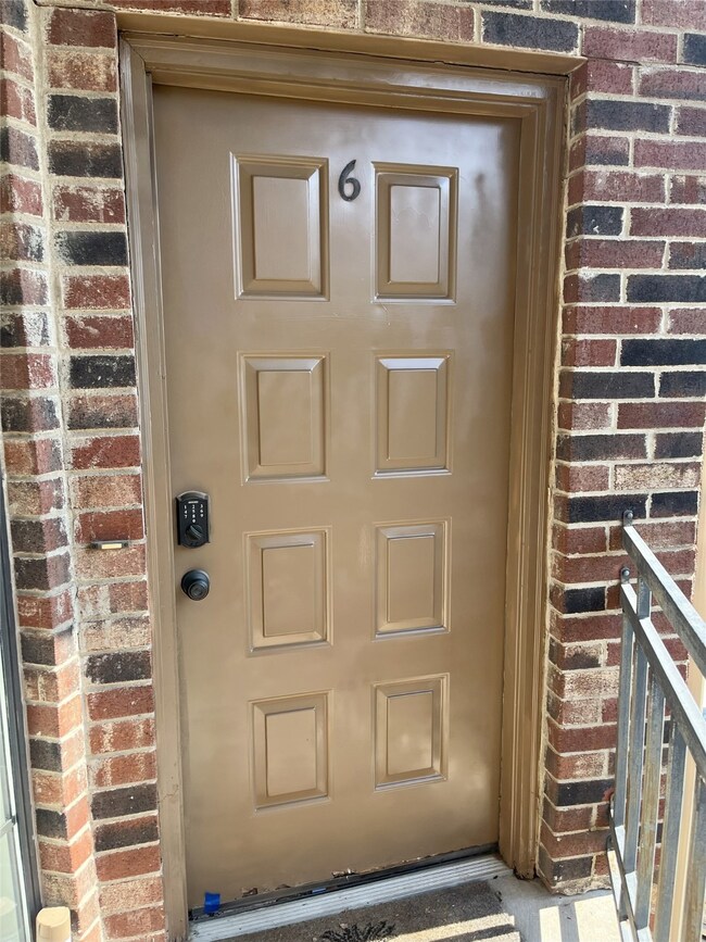 View of exterior entry with brick siding