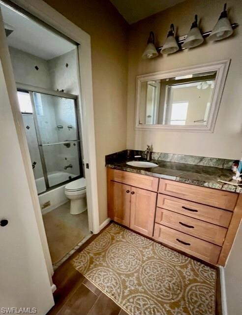 Full bathroom featuring toilet, combined bath / sh